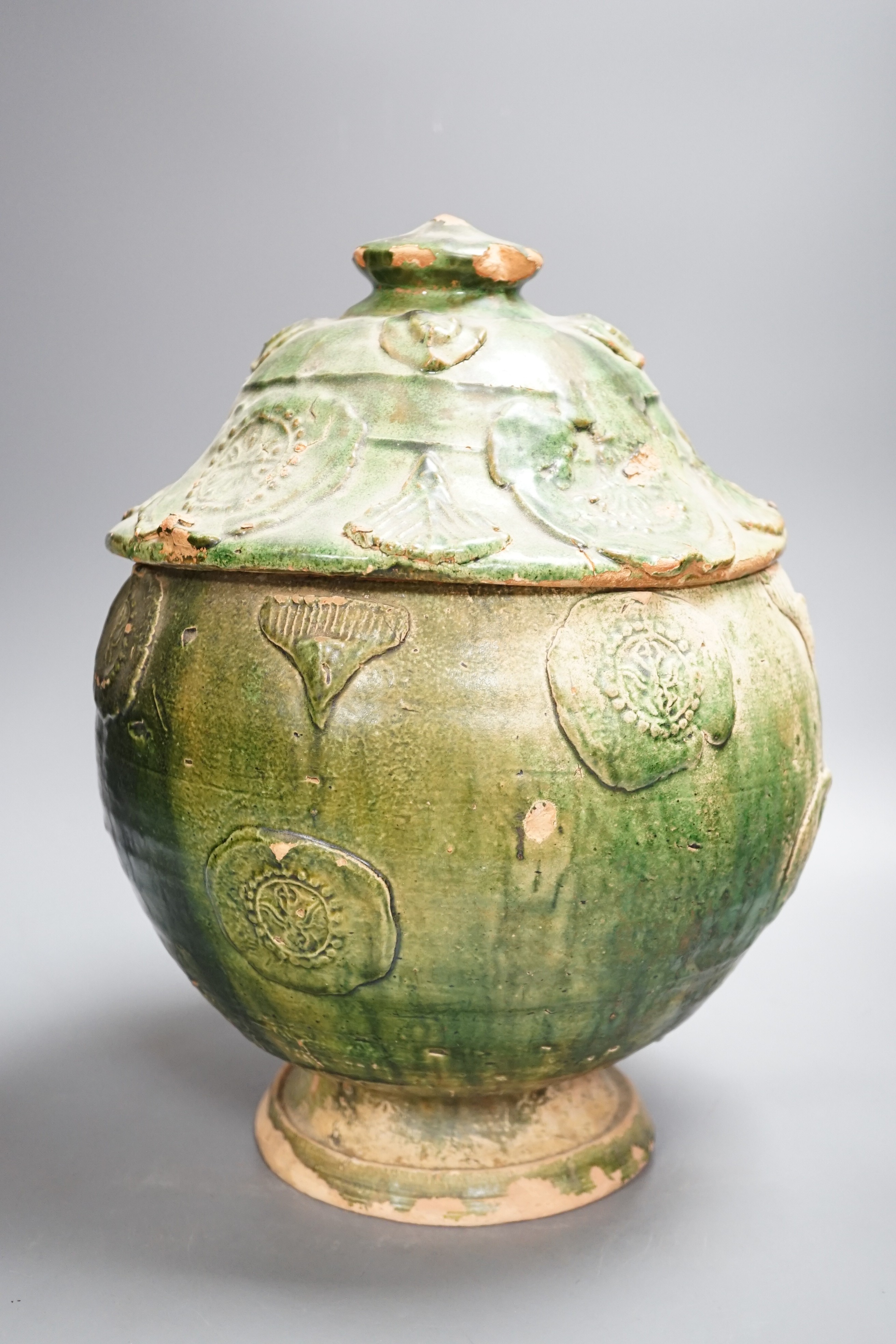 A large Chinese green glazed jar and cover, Liao dynasty, 35cm high